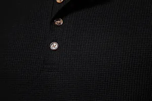 Detail of black waffle knit fabric and brown buttons on men's Henley shirt
