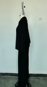 Side profile of a black Polo collar sweatshirt and wide-leg pants set on a mannequin.