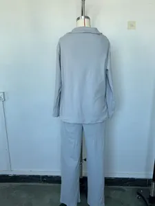 Back view of light grey women's two-piece loungewear: polo collar top and wide-leg pants.