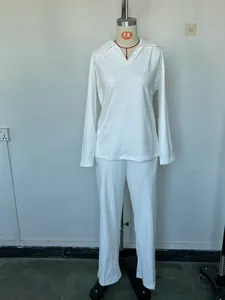 Full view of casual white long-sleeve Polo top and wide-leg trousers set on a mannequin