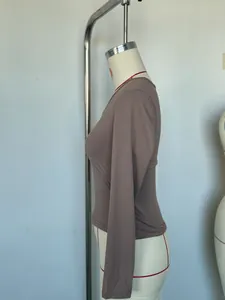 Detailed side view of a women's slim fit V-neck long sleeve top in taupe brown milk silk