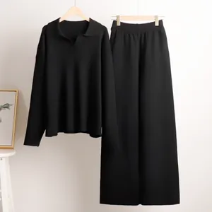 Detailed view of a stylish women's black polo collar pullover and wide-leg trouser set