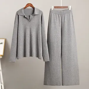 Two-piece grey knit set featuring a polo neck sweater and wide-leg lounge trousers.