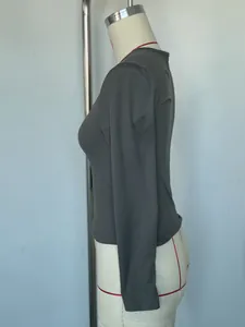 Side view detail of a slim-fit charcoal grey long-sleeved V-neck top on a mannequin.
