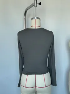 Detailed back view of a slim fit dark gray long sleeve t-shirt on a studio mannequin