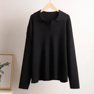 Detailed view of a minimalist black long-sleeved polo neck knit sweater on a hanger