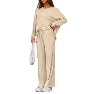 Beige women's two-piece set featuring loose long-sleeved V-neck top and wide-leg trousers