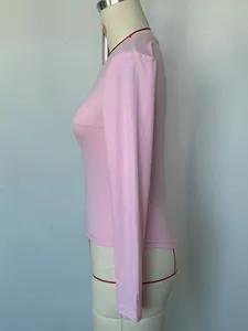 A detailed side profile view of a slim-fit pink long-sleeve V-neck base layer shirt.