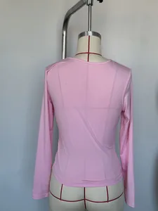 Back view of a slim fit pink long-sleeved base layer top on a mannequin torso