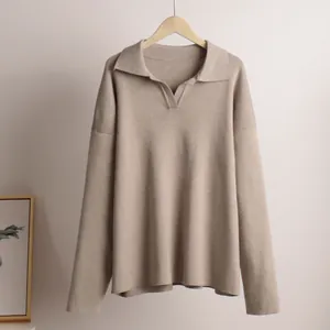 Elegant close-up of a beige Polo collar knit pullover on a natural wooden hanger