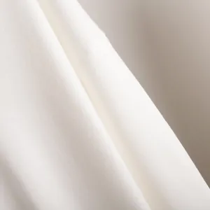 Close-up of high-quality white soft knit fabric detail showing texture and stitching