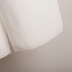 Macro view showing the soft knit texture and ribbed hem of a stylish white sweater