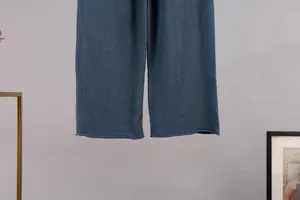 Close-up detail of the smooth hem on these navy blue knit wide-leg lounge trousers