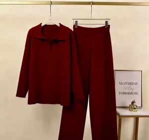 Elegant burgundy two-piece lounge set with polo collar top and matching wide-leg pants