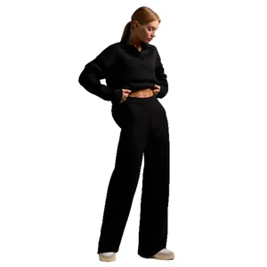 Chic black two-piece knit set featuring a polo neck sweater and wide-leg trousers for women