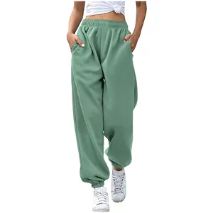 Close-up detail of high-waisted loose sage green sweatpants featuring functional pockets
