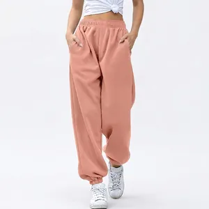 Detail of women high waisted peach joggers with elastic cuffs and convenient side pockets