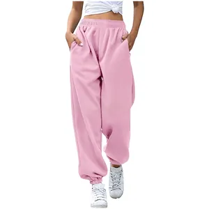 Detail view of pink high-waisted baggy sweatpants featuring functional side pockets