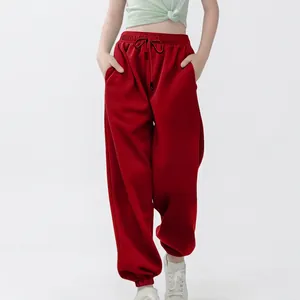 Vooraanzicht van rode baggy joggingbroek voor kinderen, toont losse pasvorm en manchetten.