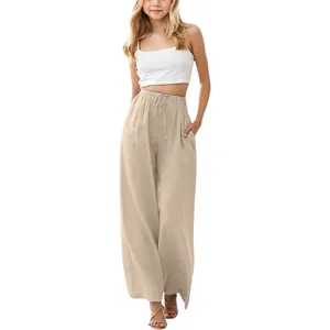 Detail view of girls' loose beige linen wide-leg pants with drawstring waist.