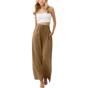 Close-up of girl's brown linen wide-leg pants featuring a drawstring waist and pockets.