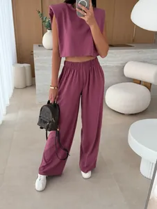 Fashionable mauve two-piece set featuring padded shoulder sleeveless top and pants