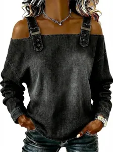 Macro view of the cold-shoulder denim texture top featuring decorative buckle straps