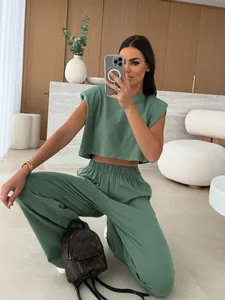 Green two-piece leisure set for women featuring padded shoulder top and wide trousers
