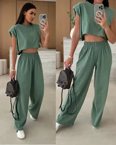 Detailed view of sage green two-piece lounge set with padded shoulder top and wide pants