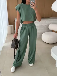Mirror selfie showing the fit and drape of a sage green padded shoulder 2-piece set
