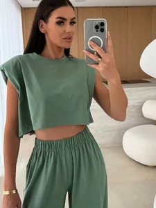 Detail shot of green women's two-piece set with padded shoulder sleeveless top and pants