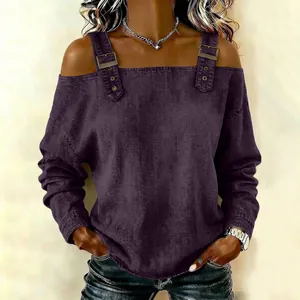 Close-up of decorative metal buckles on a purple cold-shoulder long sleeve fashion top