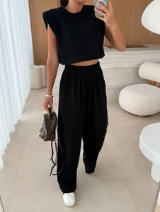 Chic black 2-piece set with padded shoulder top and wide-leg trousers for casual wear