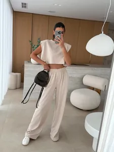 Detail of 2-piece beige women's summer set with padded shoulder top and wide-leg pants