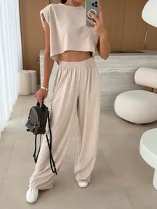 Close-up detail of beige lounge set with padded shoulder sleeveless top and wide-leg pants
