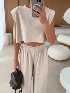 Detail view of a beige two-piece casual set featuring a padded shoulder top and matching pants