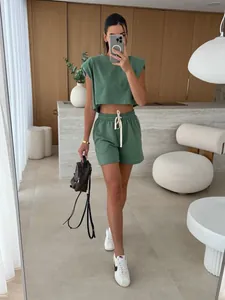 Chic green two-piece summer lounge set featuring padded shoulder top and comfy shorts