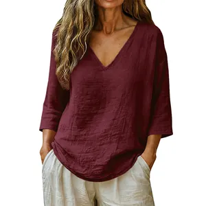 Close-up detail of women's loose V-neck top in burgundy slub cotton fabric