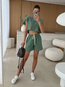 Trendy olive green two-piece set featuring padded shoulder crop top and casual shorts