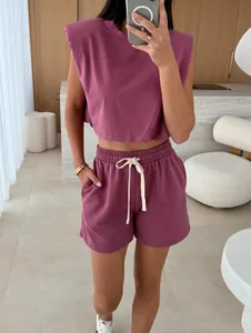 Detail view of mauve padded shoulder sleeveless crop top and matching drawstring shorts.