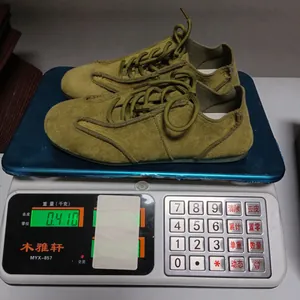 Detail showing weight of olive suede German Army Trainer shoes on a digital scale