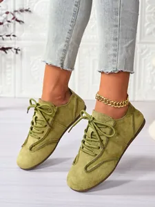 Close-up view of olive green suede lace-up casual flats for women in a comfortable style