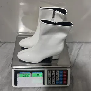 White block heel ankle boots with side zipper weighing 0.550kg on a digital scale.