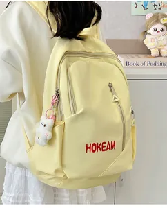 Detailed view of the yellow large-capacity backpack featuring the HOKEAM logo print