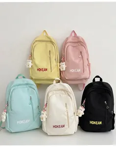 Collection of large capacity minimalist backpacks in multiple pastel colors with bear charms
