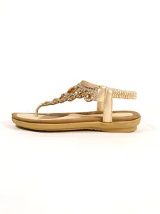 Side view of gold flat sandals with sparkling rhinestone floral decorations