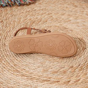 Detailed view of the anti-slip floral patterned rubber sole on Bohemian flat beach sandals