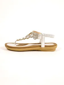 Elegant women's flat sandals with sparkling rhinestone floral detailing in side profile view