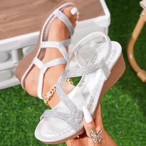 Detailed view of silver bohemian wedge sandals with textured straps and comfortable heel