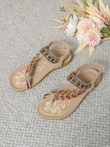 Detailed shot of Bohemian ethnic flat sandals with intricate beading and heart accents